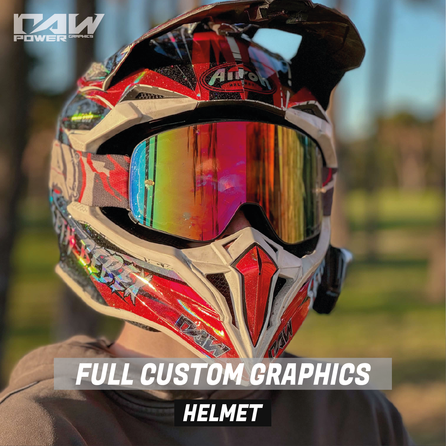 Motorcycle helmet with custom graphics and reflective visor against a blurred natural background